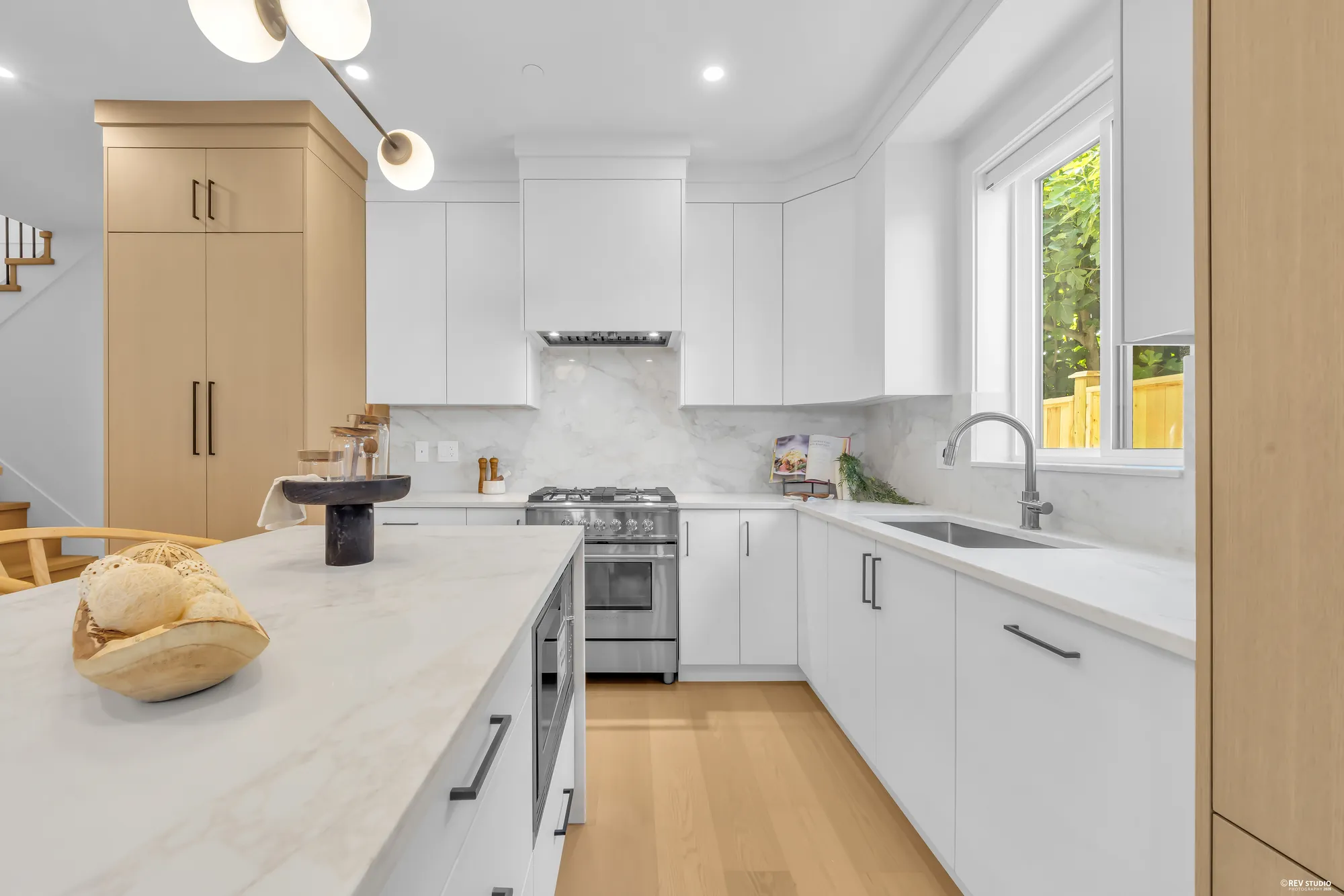 Kitchen counter run with gas range and stone backsplash