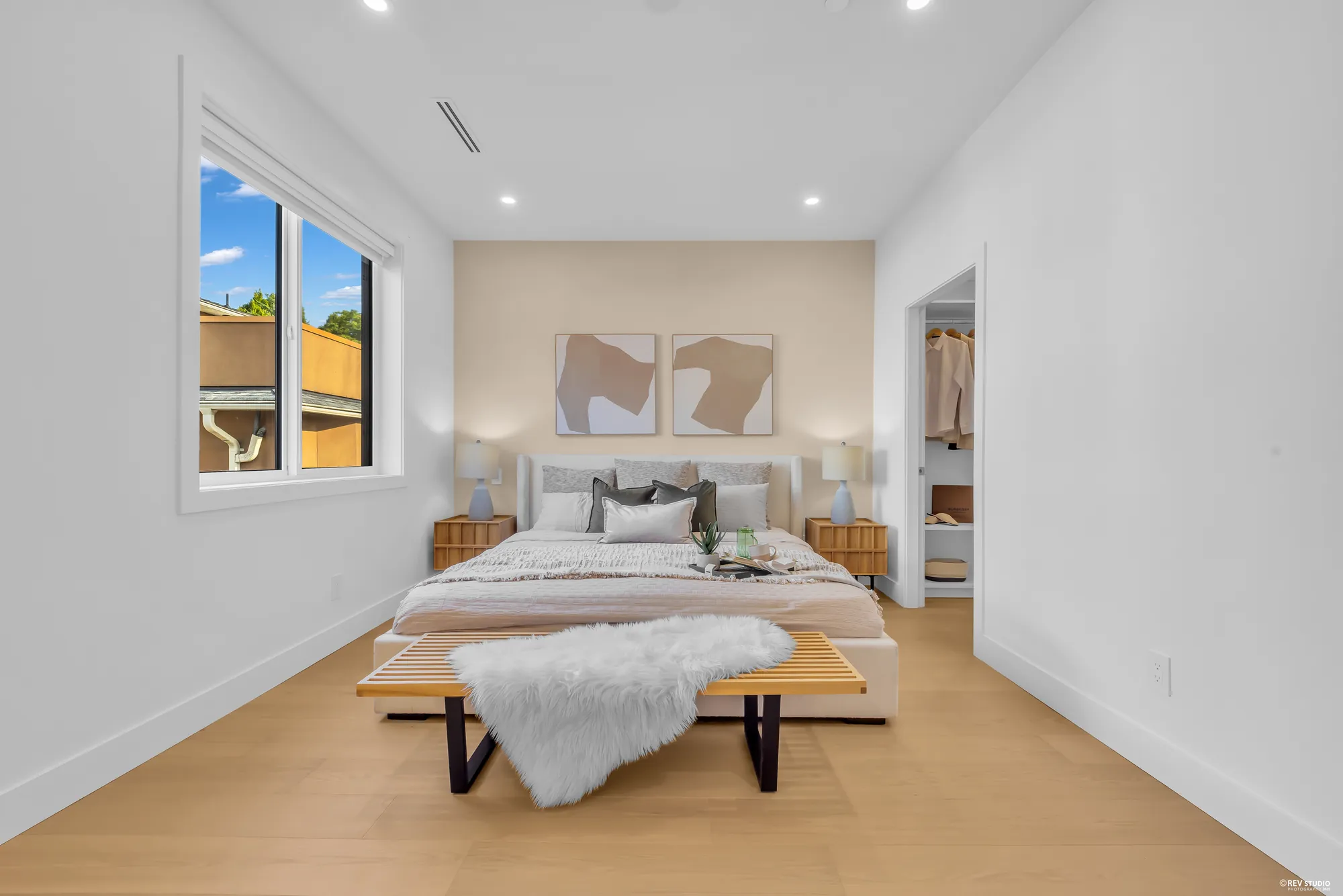 Primary bedroom with the bed against the window wall
