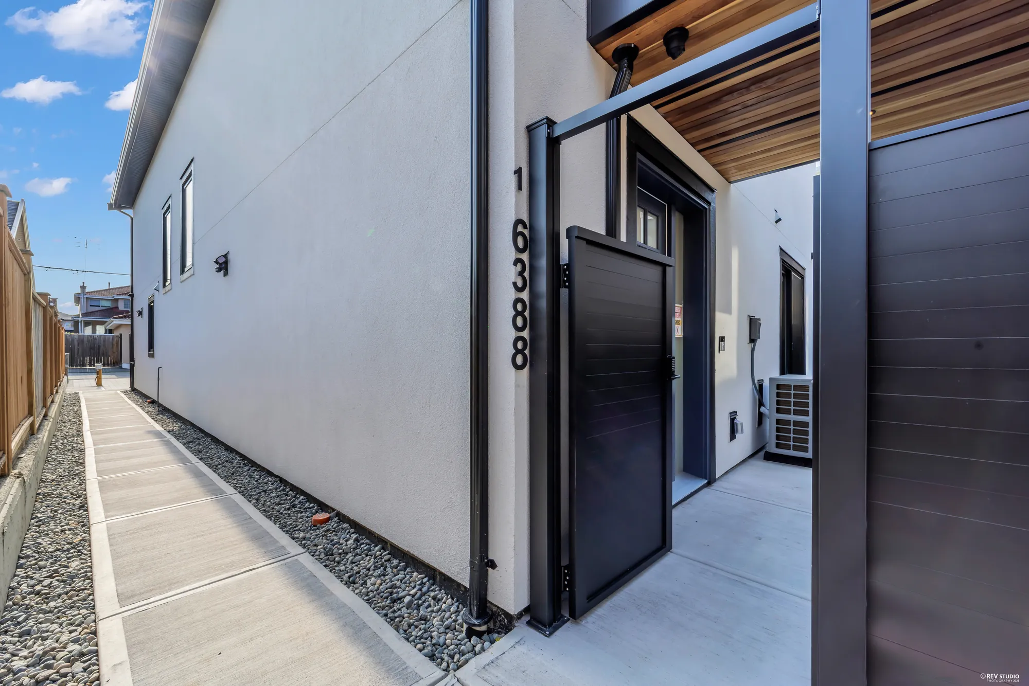 The side path to the rear building with the address on the wall